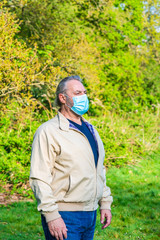 Portrait of a middle aged male wearing protective face mask whilst outdoors