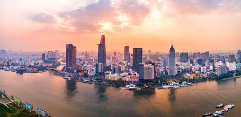 Naklejka premium Top view aerial photo from flying drone of a Ho Chi Minh City with development buildings, transportation, energy power infrastructure. Financial and business centers in developed Vietnam.