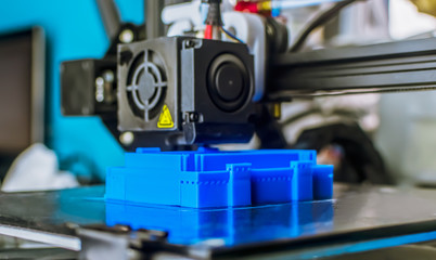 The 3D printer prints blue plastic model