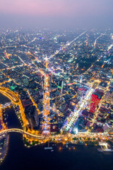 Obraz premium Top view aerial photo from flying drone of a Ho Chi Minh City with development buildings, transportation, energy power infrastructure. Financial and business centers in developed Vietnam.
