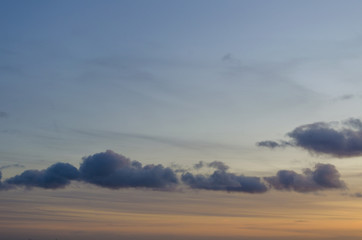 Warm and cold coloured sky with some clouds during a sunset
