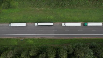 Aerial view: Big queue of trucks. Trucks wait in line for border crossing control. Top view.