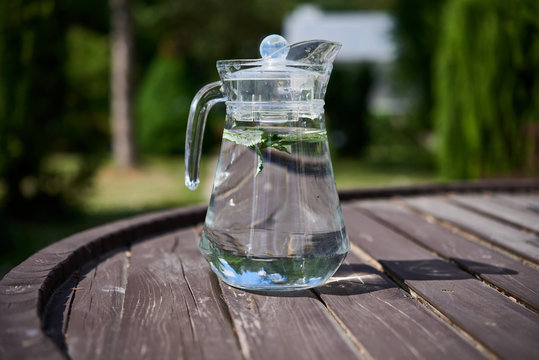 Jug of water with lemon outdoors