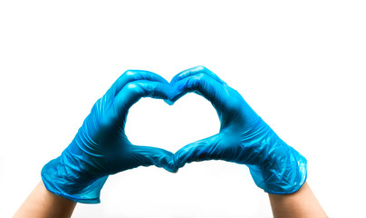 Obraz premium The doctor’s hands in gloves show the heart. Support and love. Stay home.