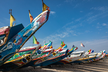 Traditional painted wooden fishing boat in Djiffer, Senegal. West Africa. - obrazy, fototapety, plakaty