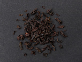 Dry black tea leaves isolated on white background, top view