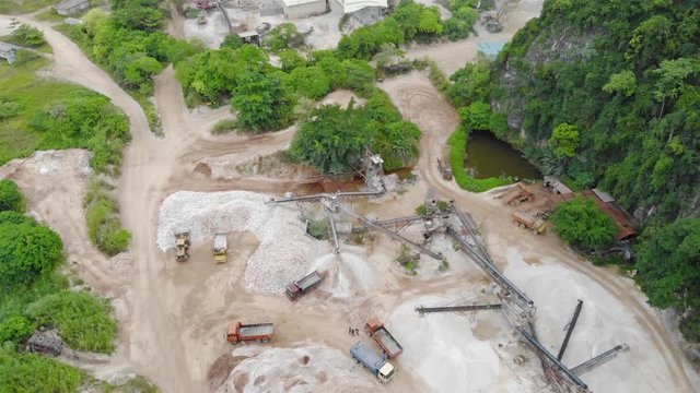 Construction site with small pond and empty space while heavy equipment parked - dolly forward