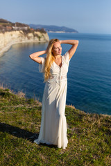 Fototapeta na wymiar Blonde model at the sea at summer
