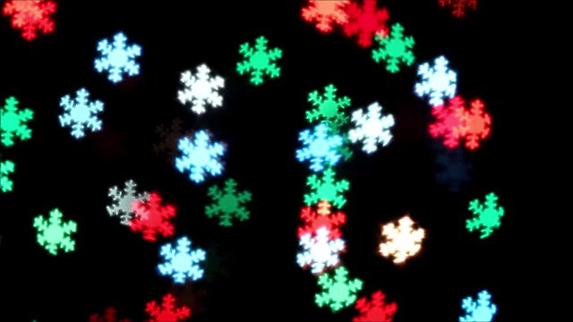 Flashing multicolored lights. Christmas garland of snowflakes on a dark background. New year and Christmas footage.