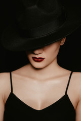 Fototapeta na wymiar portrait of a beautiful girl in a black hat and dress