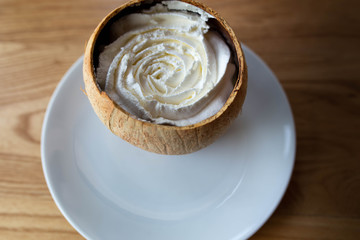 Beautiful white cake serve in coconut shell.