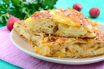 Burek Turkish pie. Lavash puff pie with cheese and sesame seeds