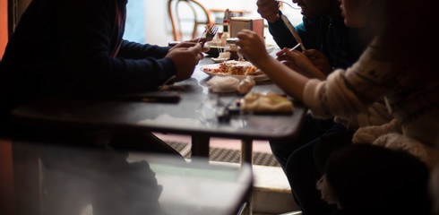 Silhouette of a group of young friends having lunch in a restaurant in a festive day. Indian lifestyle.