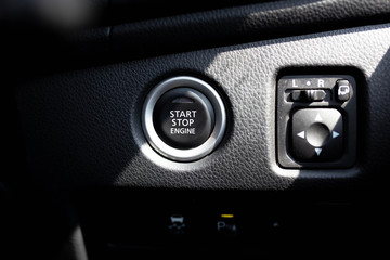 Start stop engine button on a modern car dashboard.