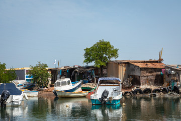 Fototapeta na wymiar Old and abandoned ships anchored in Banjul Bay, at low tide.