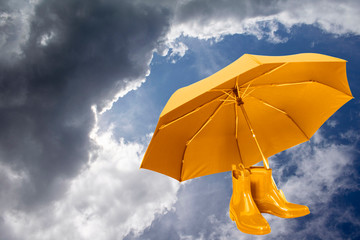Yellow umbrella on the sky background