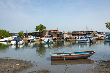 Fototapeta na wymiar Old and abandoned ships anchored in Banjul Bay, at low tide.