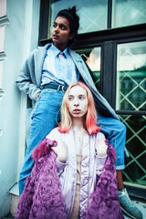 Two teenage girls infront of university building smiling, having fun, lifestyle real people concept