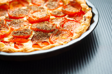French tomato and mustard tart, baked in puff pastry and seasoned with herbs de provence. A tasty alternative to pizza.