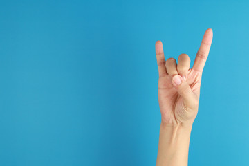 Woman hand rocker. Hand giving the devil horns gesture isolated on white background