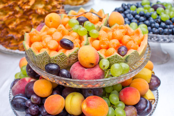 Melon basket. Decorative artistic fruit carving. Wedding catering company table tray. Colorful vitamin background. Various selection of fruits on banquet reception.