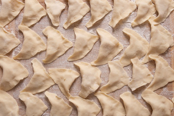 Dough dumplings with potatoes lie on a cutting board. Cooking at home.