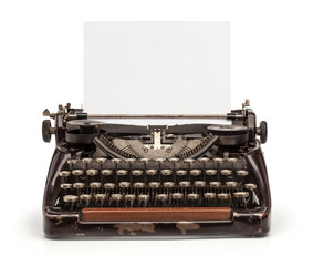 Old vintage typewriter and a blank sheet of paper inserted. Isolated on white background.