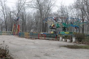 an old soviet carousel in the autumn park on a cloudy day