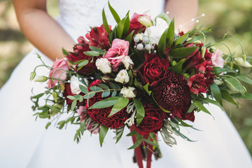 the bride holds a bouquet in her hands