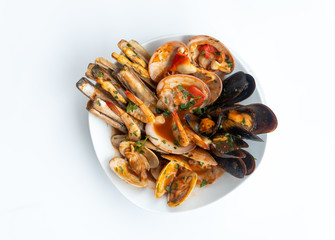 Sauteed shellfish and seafood in a white plate on a white background