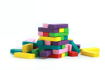 Closeup of colorful wood blocks stack game on white background. Hobbies and leisure concept.