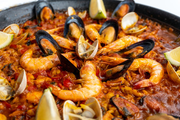 Fish and seafood paella on a white background