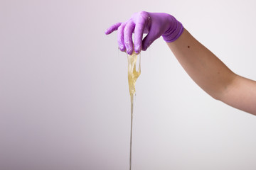 hand holding a sugaring sugar wax
