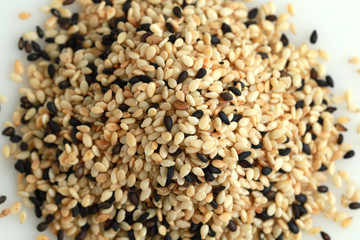 Top view pile of white and black sesame isolated on white background.