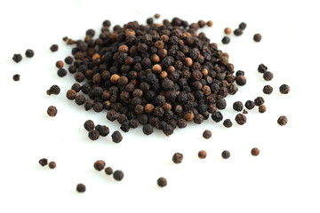 Pile of black peppercorns isolated on white