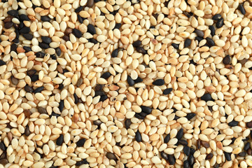 Top view pile of white and black sesame isolated on white background.