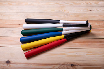 Fototapeta premium colorful baseball bats on the wooden floor