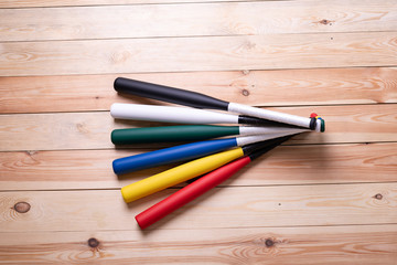 Fototapeta premium colorful baseball bats on the wooden floor
