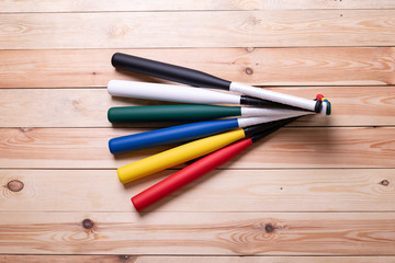 colorful baseball bats on the wooden floor