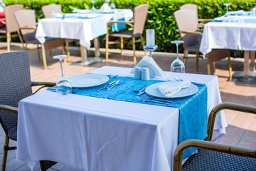 Cozy restaurant table setting in blue style with sea view