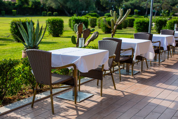 Cozy restaurant table setting in blue style with sea view