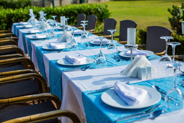 Cozy restaurant table setting in blue style with sea view