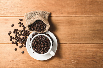 Top view flat lay coffee bean in cup on wooden.