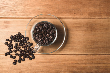Top view flat lay coffee bean in cup on wooden.