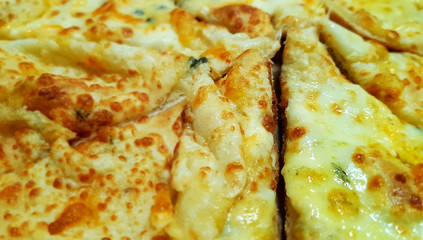 A pieces of four cheese pizza close-up
