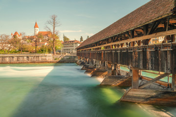 Picturesque view of Thun Castle in the city of Thun, with beautiful old wooden bridge over the river, canton of Bern, Switzerland