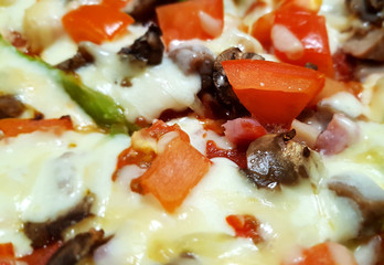 A piece of delux pizza close-up