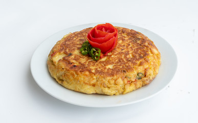 Tortilla espanola, Spanish omelette with potatoes with a tomato flower on top