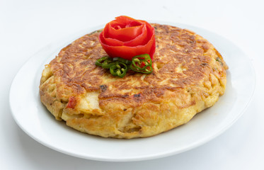 Tortilla espanola, Spanish omelette with potatoes with a tomato flower on top