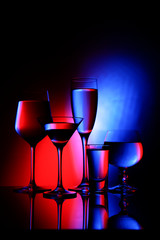 
Five glass goblets on color gradient background